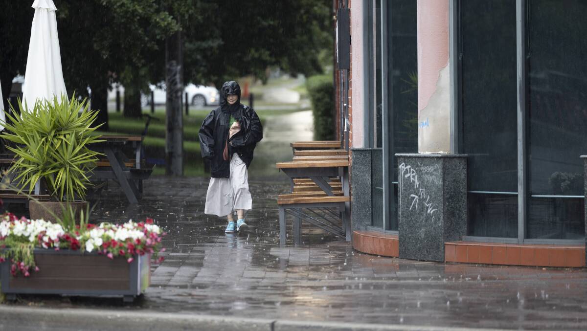 Some Canberrans were caught short without a brolly on Saturday afternoon when a large storm passed through the bush capital. Picture by Gary Ramage 