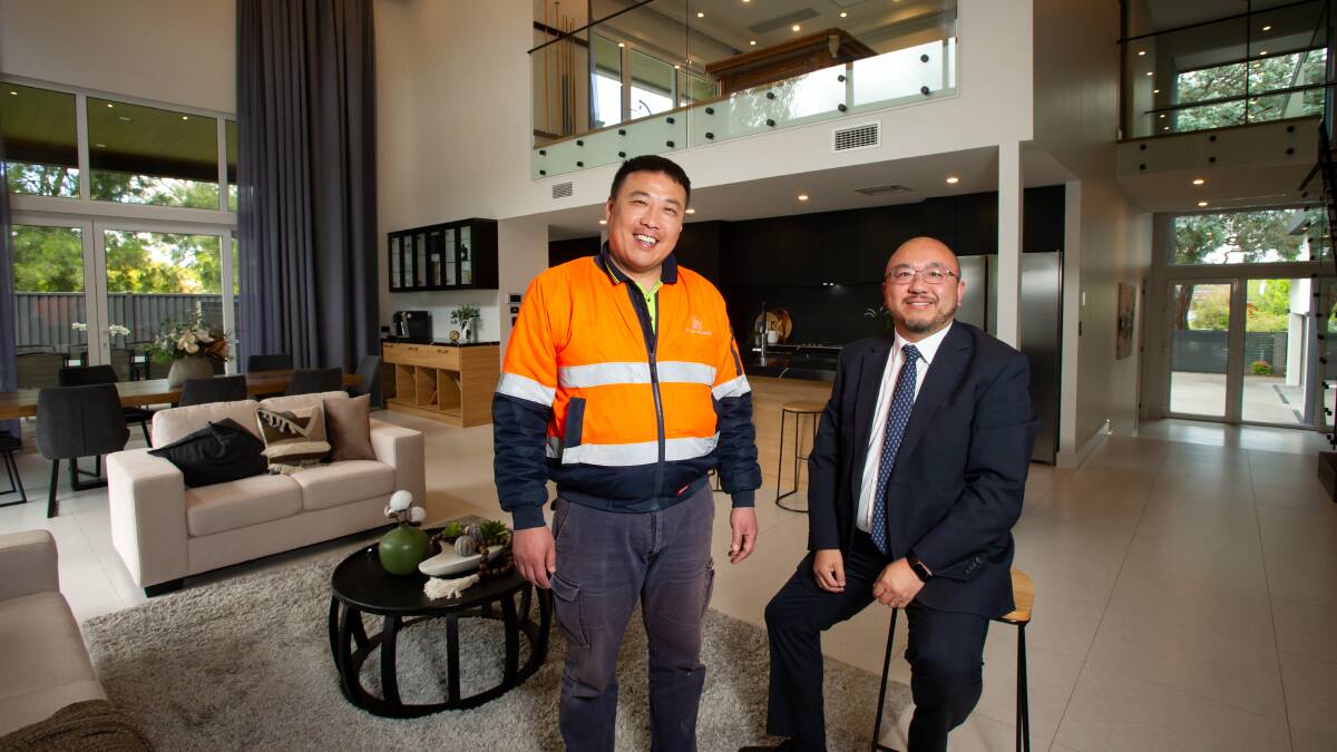 Seller Qi Zhang and real estate agent Michael Wang pictured inside the six-bedroom home that broke the Macquarie suburb record. Picture by Elesa Kurtz