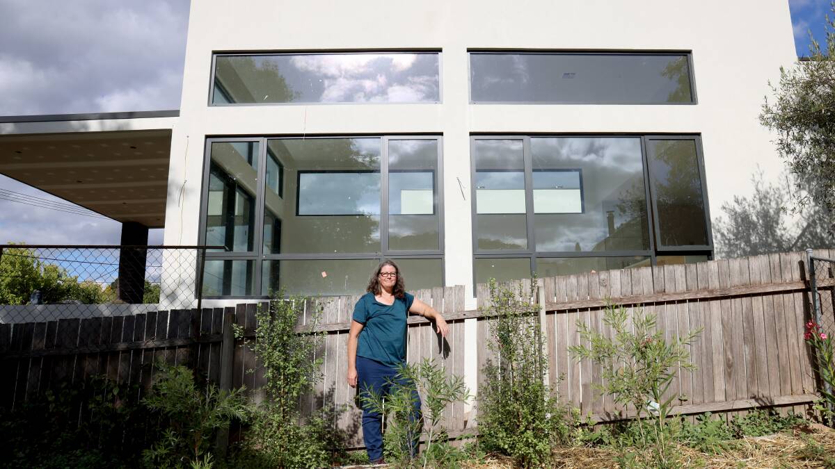 Fiona Carrick in her Torrens backyard, which is now overlooked by a new development. Picture by James Croucher