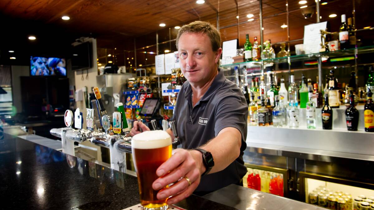 Kambah Inn manager David Charman pours a beer as the pub hits the market. Picture by Elesa Kurtz