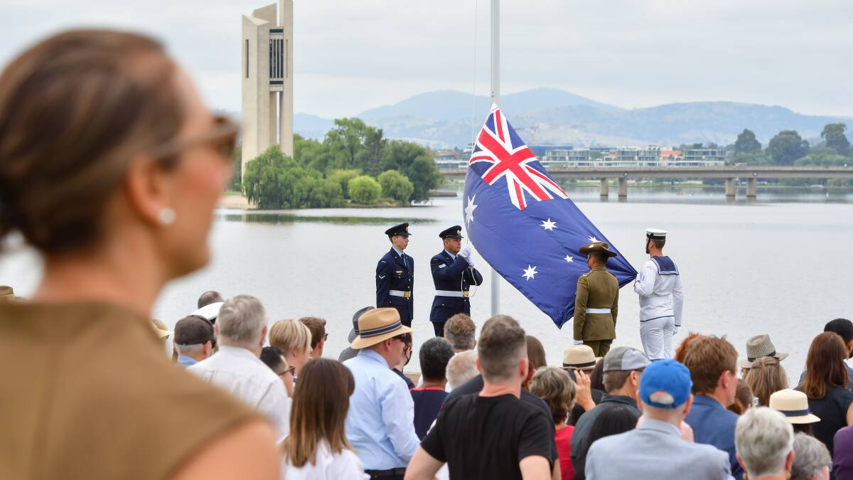 The Australian flag is raised at the 2022 Australia Day citizenship ceremony in Canberra. Picture by Elesa Kurtz