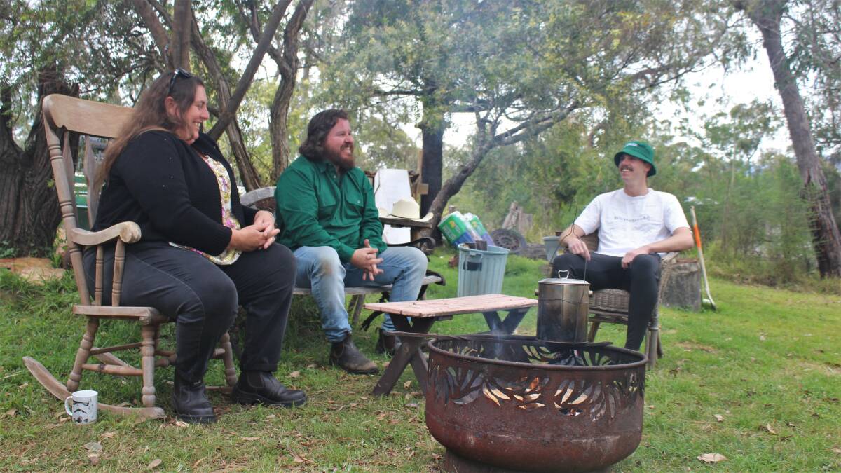 The Green Care Eurobodalla team in their office around their fire. From left to right: Joey Collins, Matt Keating and Jack Boyce-Norman.