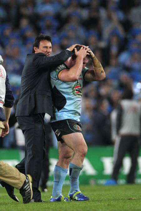 Laurie Daley celebrates the 2014 NSW win with Paul Gallen. Picture by John Veage