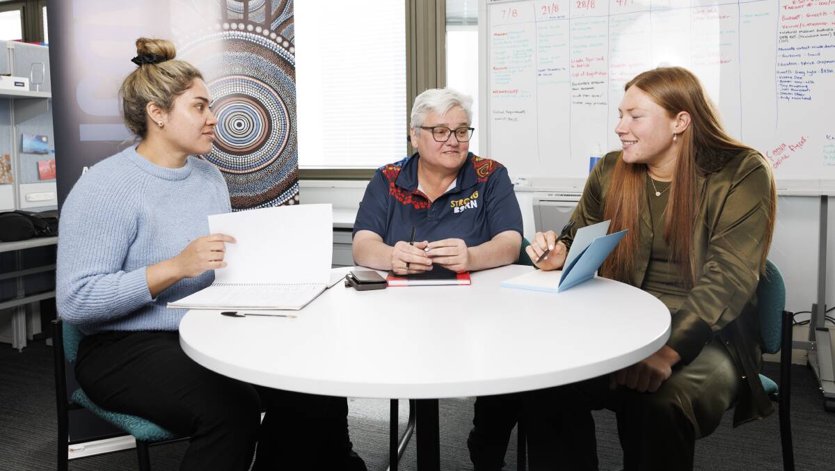 Grace Kemp, right, and Tommaya Kelly-Sines, left, with Raiders board member Katrina Fanning at the Coolamon Advisors office. Picture by Keegan Carroll