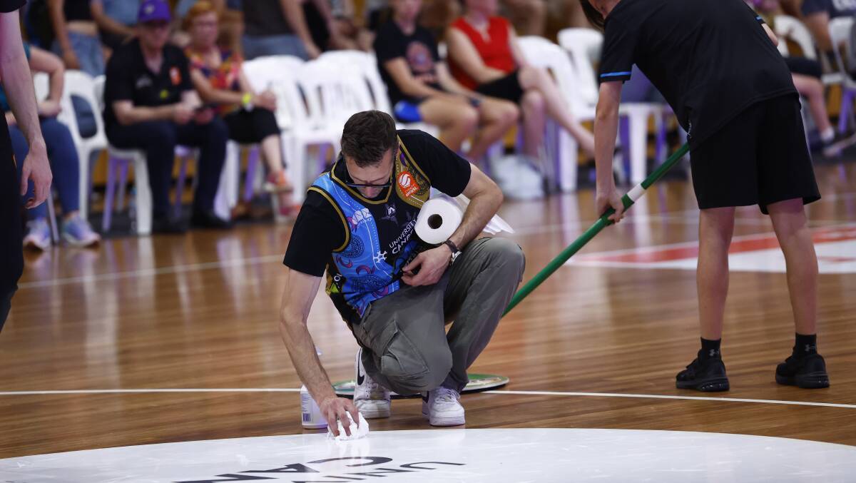 Staff clean up blood from Boomers player Jordin Canada. Picture by Keegan Carroll