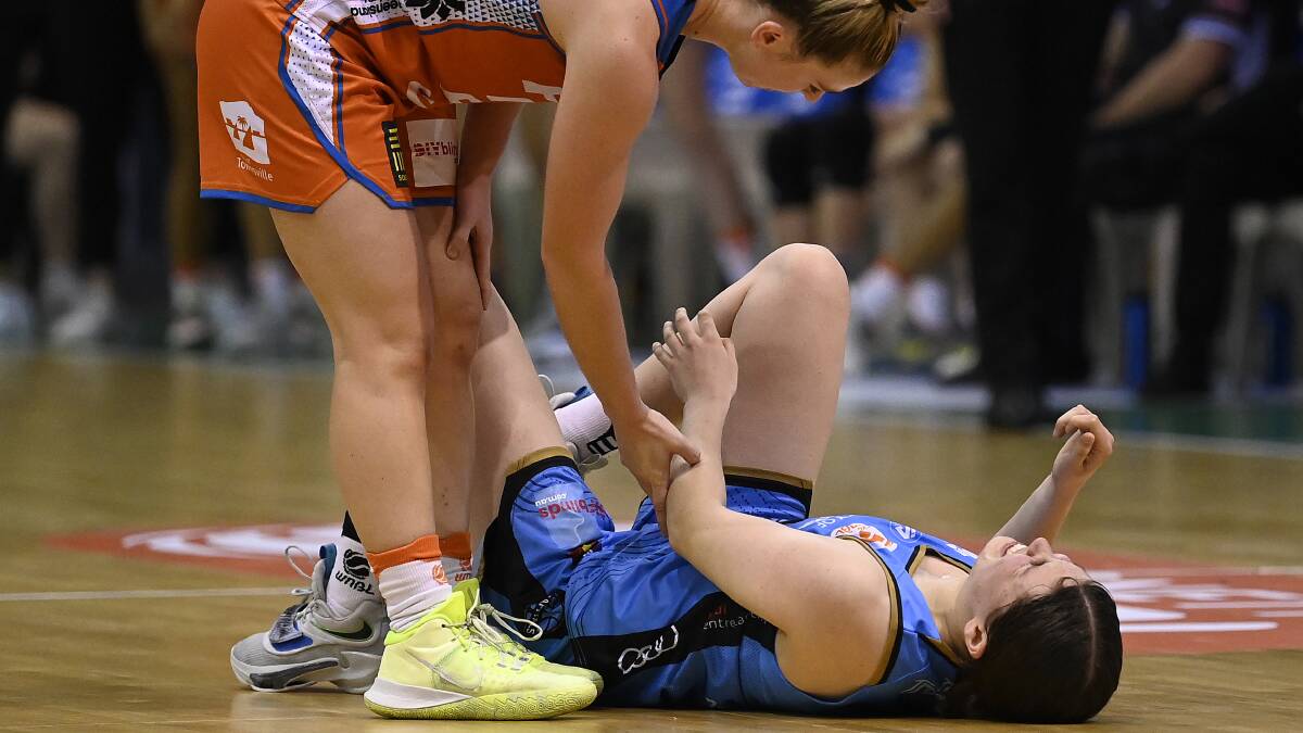 Jade Melbourne went down in the third quarter against the Townsville Fire. Picture Getty Images