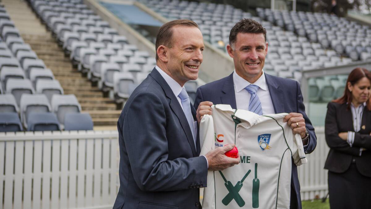 Tony Abbott, with captain of the Prime Minister's XI Mike Hussey in 2015. Picture by Jamila Toderas