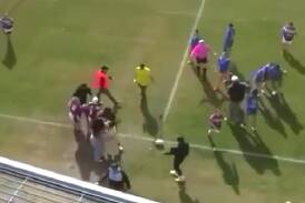 Spectators and players are involved in a scuffle in the Katrina Fanning Shield. Picture Bar TV Sports