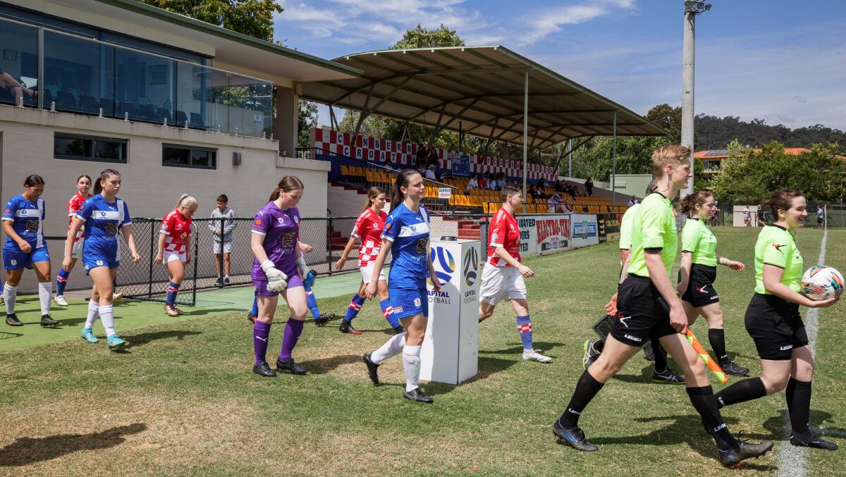 Canberra Croatia and Canberra Olympic players line up for the start of the Capital Football Charity Shield at Deakin Stadium on Saturday. Picture by Sitthixay Ditthavong
