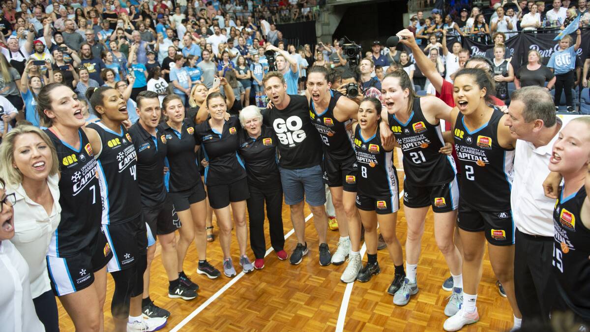 Canberra Capitals celebrating winning the WNBL title in 2019 at the AIS Arena. Picture by Sitthixay Ditthavong