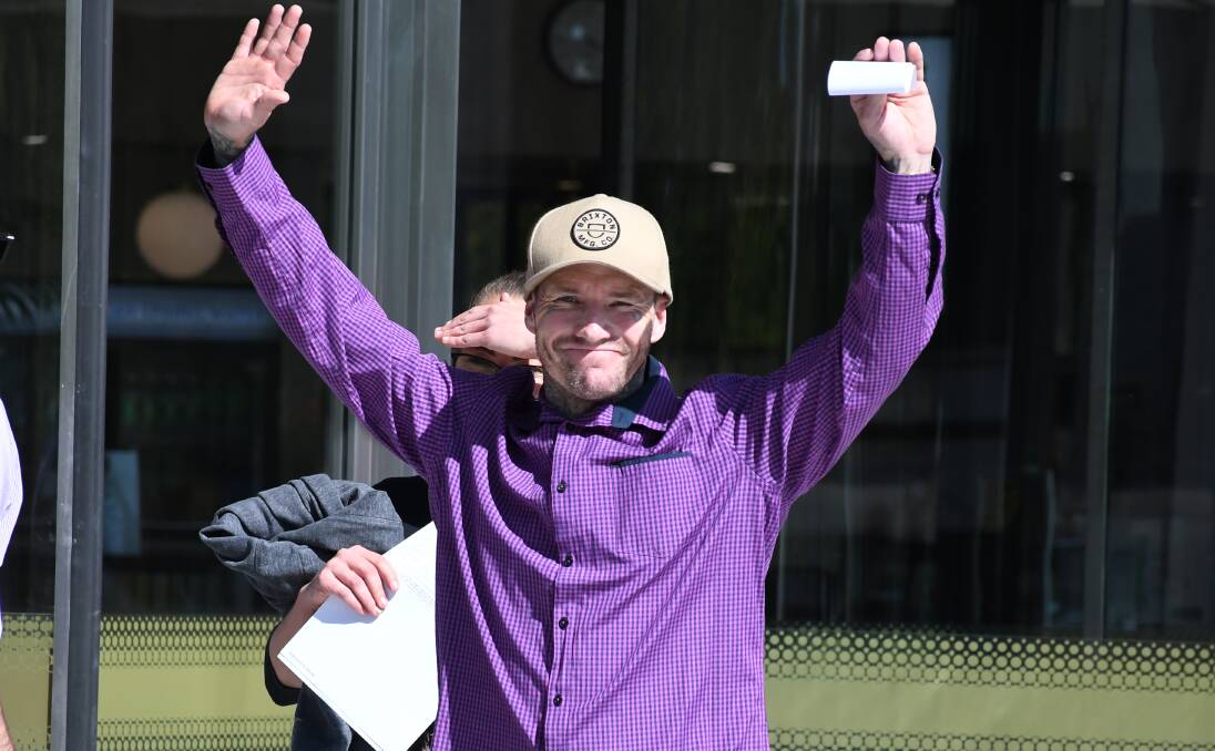 Mitchell MacNaughton waves to media cameras outside court on Tuesday. Picture by Tim Piccione 