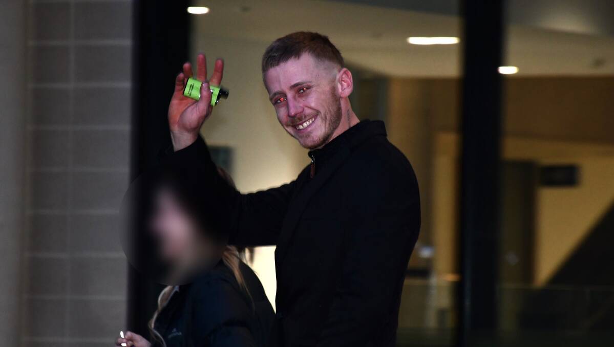 Aiden Paff waves to a media camera as he leaves court on Wednesday. Picture by Tim Piccione 