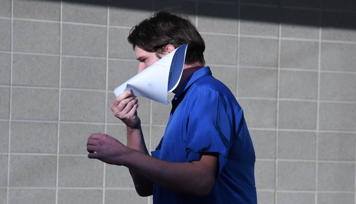 Cameron McKay hides his face from media cameras as he leaves court on Thursday. Picture by Tim Piccione 