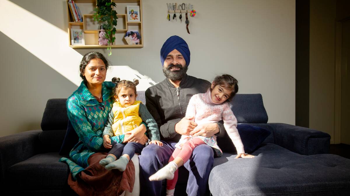 Indian-born Australian Jarnail Singh is truly content with the family he's built in Canberra. Here, he is pictured with children Gurjaap Kau,r 4, and Uqaab Kaur, 2, and wife Bhawandeep Kaur in their home. Picture by Elesa Kurtz