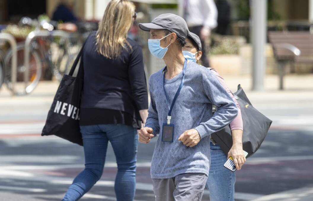 Pedestrians masked up in Canberra in November last year. Picture by Gary Ramage