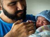 Saad Khan holds his new son Azlan Khan after mum Maryam Khan gave birth at North Canberra Hospital, one of two locations trialling the new system. Picture by Karleen Minney.