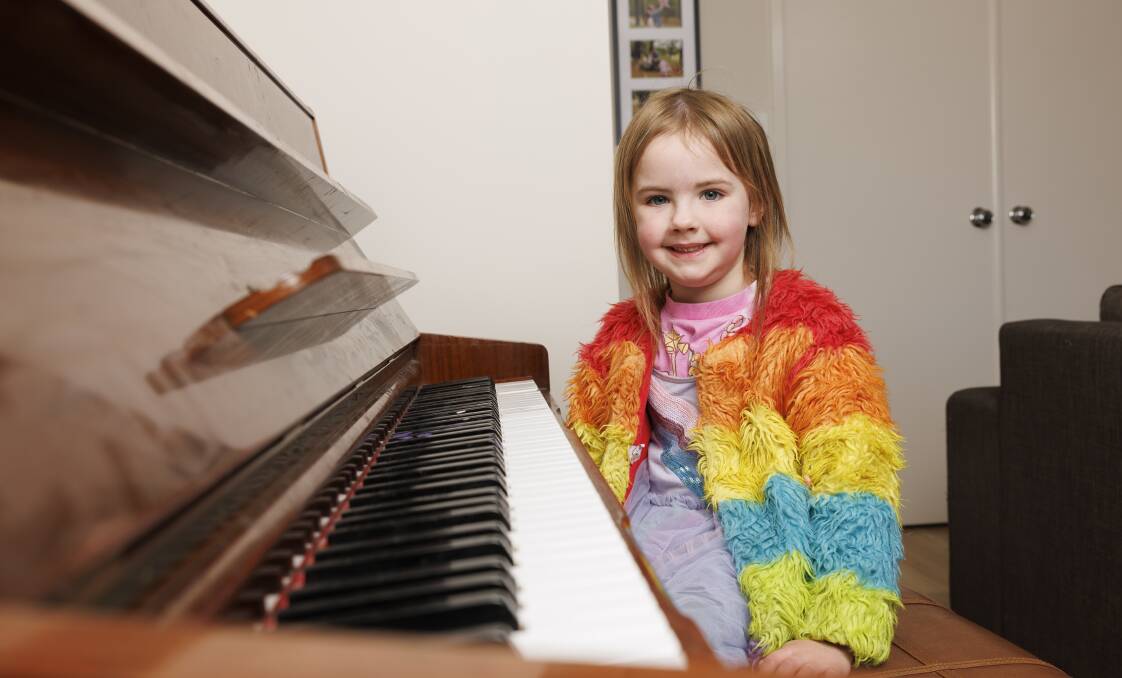 Gifted child Genevieve Davis, 4, sits by her beloved piano at home, she could read sheet music before she turned two. Picture by Keegan Caroll