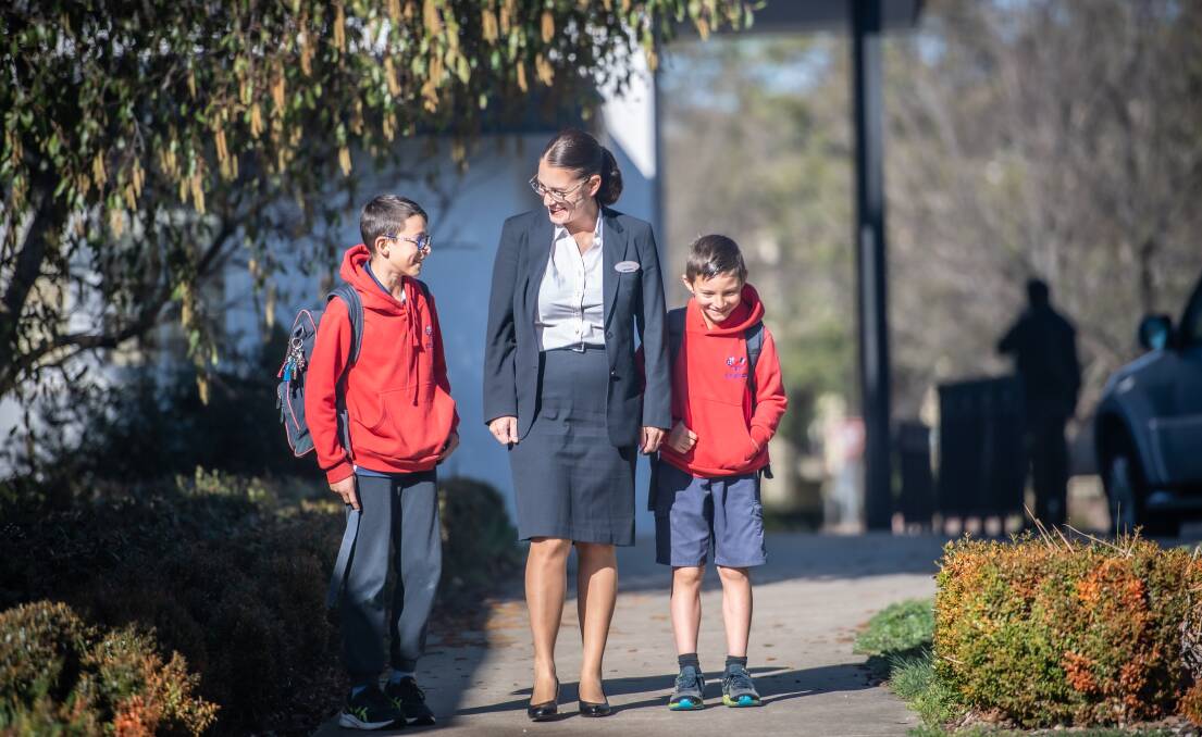 Veronique Francesconi with her two sons Nolan, 11 and Enzo, 8, outside Telopea Park School in south Canberra. Picture by Karleen Minney