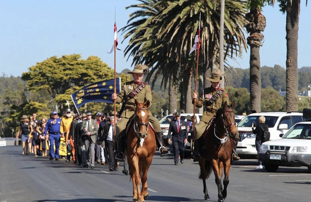 Members of the Light Horse Chris Red (left) and son Isaac (right) march in Bermagui on Anzac Day. Picture supplied.