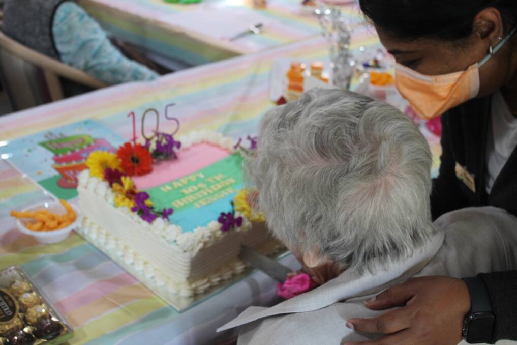 Jessie cutting her 105th birthday cake. Picture Tom McGann. 
