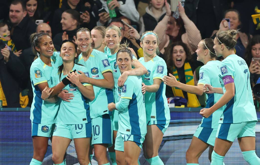 The Matildas get around their teammate Hayley Raso after scoring a goal. Picture Getty Images