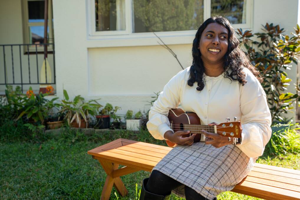 Abby Jayasuriya playing the ukulele at her home in Sydney. Picture supplied 