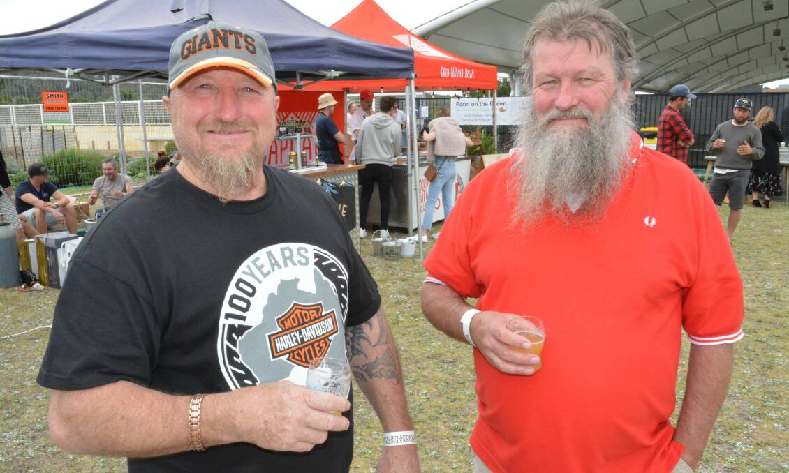 Robert Baxter and Paul Sargent enjoying a beverage at 2021 'Merimbula Craft Beer Festival', now called South Coast BevFest. Picture by Ben Smyth. 