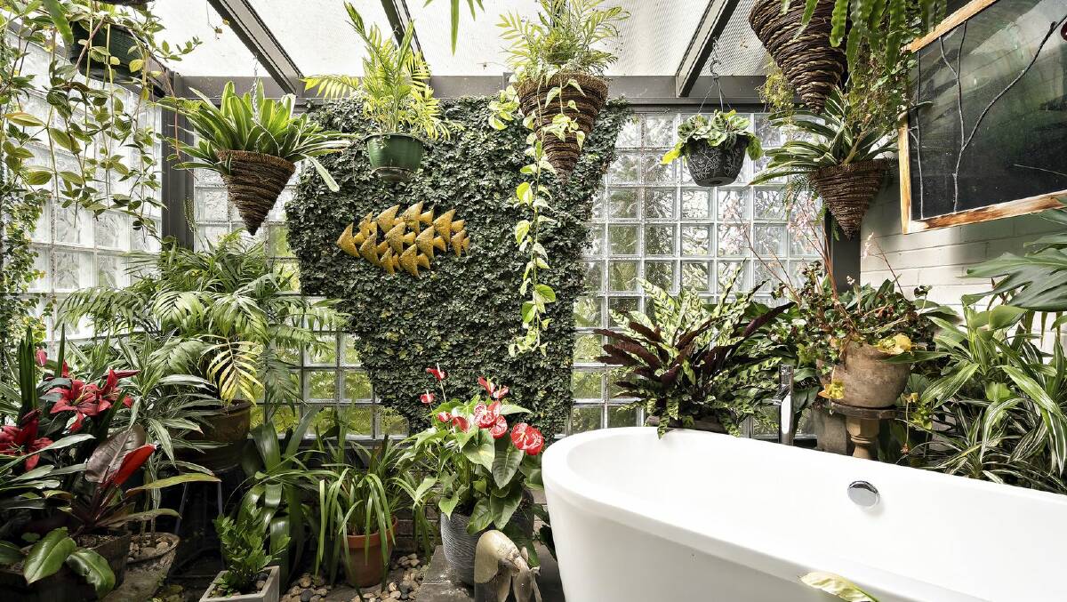A free-standing bathtub amongst greenery is part of this house's appeal. Picture supplied