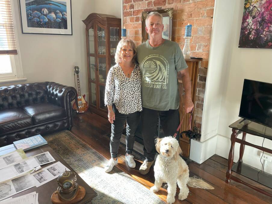 Exposed brickwork around the fireplace adds warmth to the second living room. Robyn and Dave Brannan smile with their dog Lilly. Picture by James Parker