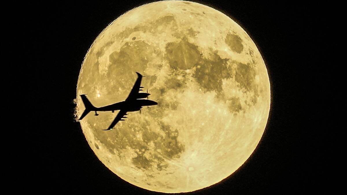 An aircraft flies in front of August's supermoon in Turkey. Picture by AP Photo/Emrah Gurel