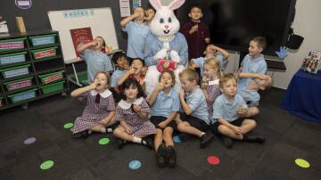 The principal of Sacred Heart Primary School in Pearce, David Austin, dressed up as the Easter Bunny to entertain the playgroup kids aged 2, 3, and 4.