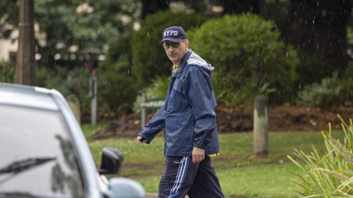 Mike Pezzullo was spotted walking in the rain in Kingston. Picture by Gary Ramage.
