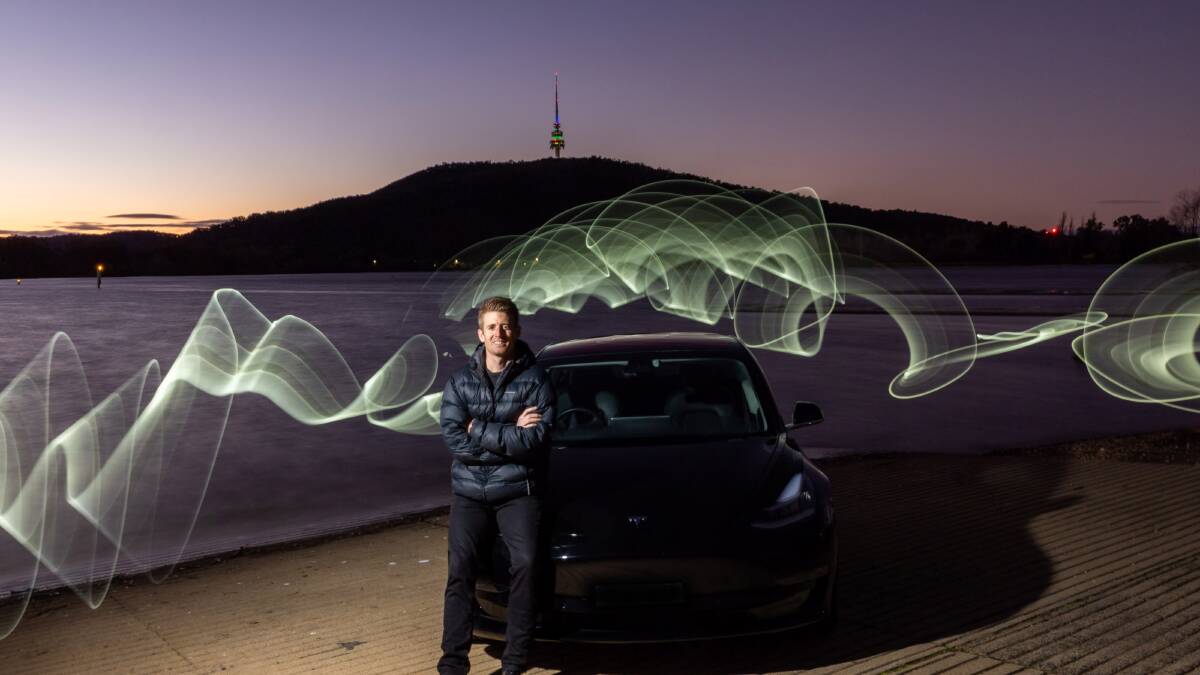 Daniel Bleakley with his Tesla and a puffer jacket. Picture by Gary Ramage