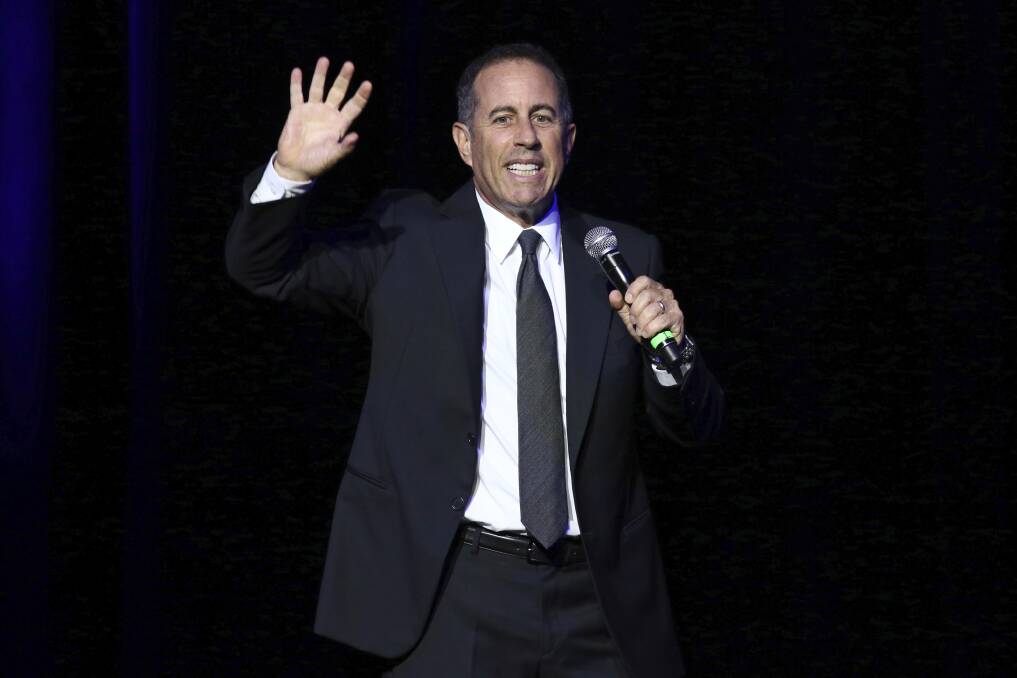 Comedian Jerry Seinfeld performs on stage. Photo by Greg Allen/Invision/AP