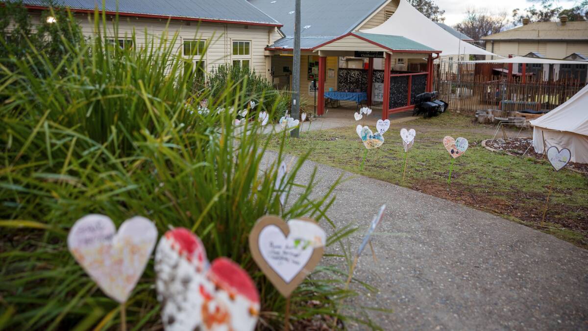 Hearts made by the community line the path to the ANU Heritage early childhood centre, which is one of four in danger of closing. Picture by Sitthixay Ditthavong