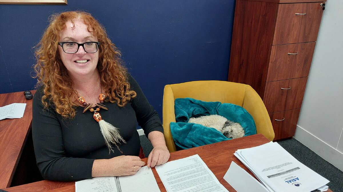 Heidi Pritchard, the new managing director of the National Folk Festival, in the festival offices at Mitchell with Rosie, one of her foster dogs. Picture supplied
