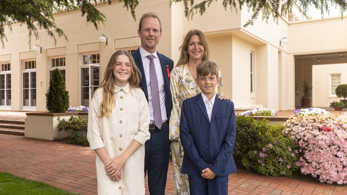 Richard Davies and wife Kate and their children Emma, 12, and Edward, 11, at Government House yesterday after he received his bravery award. Picture by Keegan Carroll