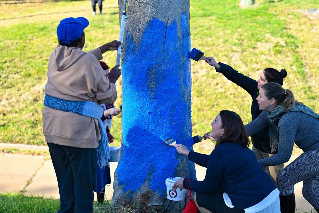 Aunty Lydia George painting with ACT govenment staff Cheryl Garrett, Cassandra Tinning, Rebecca McIntyre and Brooke Dyason. Picture supplied