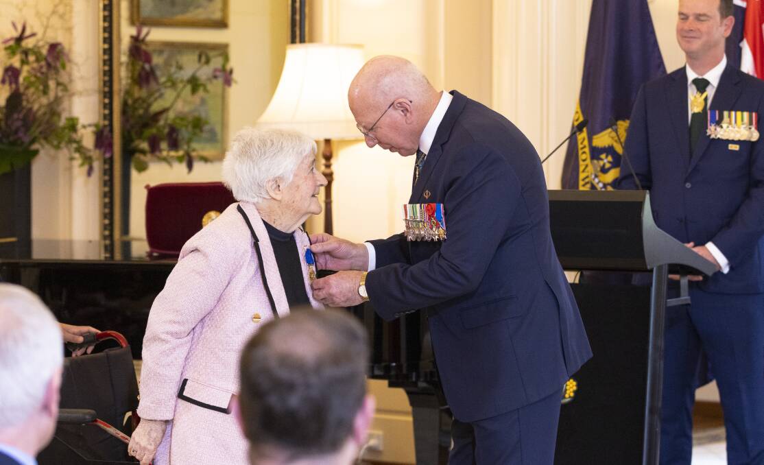 Retired Crookwell teacher Helen Campbell rose from her wheelchair to receive her OAM for services to music from Mr Hurley on Tuesday. Picture by Keegan Carroll