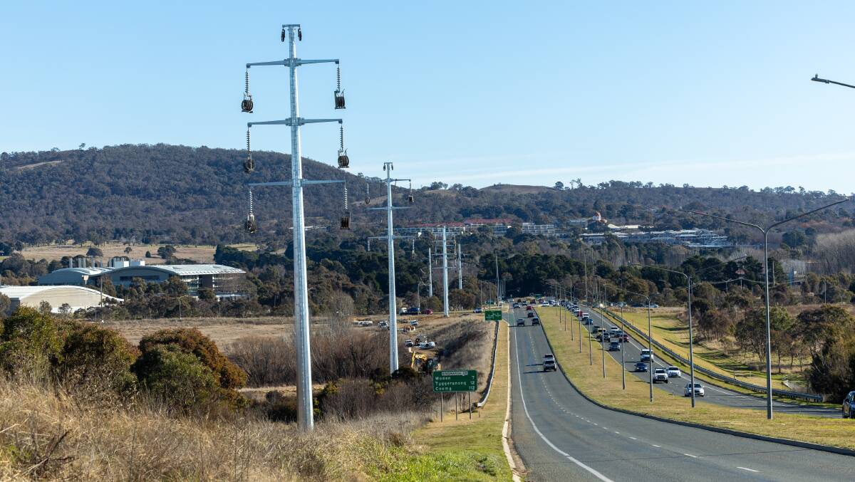 Some of the new electricity poles being constructed on Hindmarsh Drive between Newcastle Street and the Monaro Highway. Picture by Gary Ramage