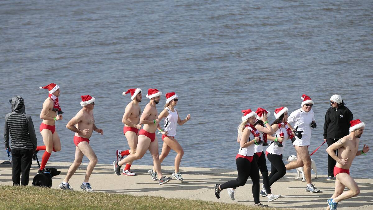 The Santa Speedo Shuffle involved runners and walkers donning Speedos and Santa hats and doing the bridge-to-bridge around Lake Burley Griffin in the middle of winter to raise money to support locals with cystic fibrosis. Picture by Jeffrey Chan