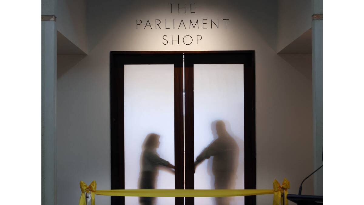 Staff get ready to open the doors on the revamped shop at Parliament House. Picture by The Canberra Times