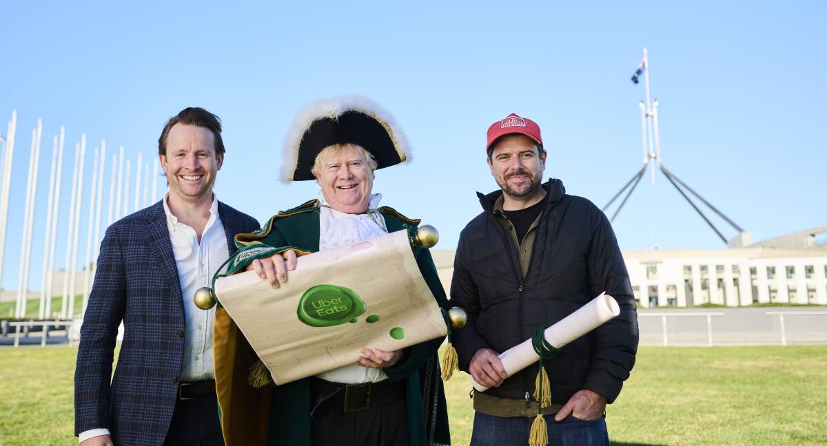 Uber Eats regional general manager (retail) Lucas Groeneveld, left, joined the town crier and Capital Brewing co-founder Laurence Kain for the petition launch. Picture supplied 
