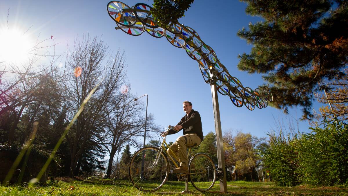 Oscar Gardner on the sculpture in Turner that he made from old bike wheels from The Green Shed. Picture: Elesa Kurtz