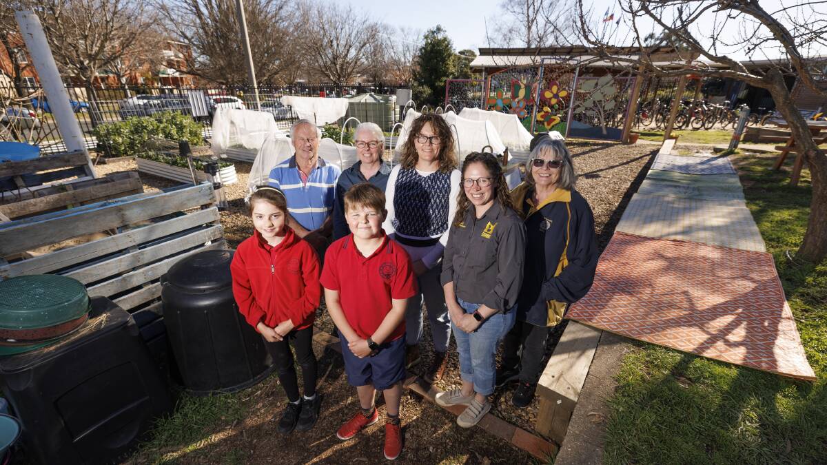 Majura Primary students Anna Bint and Tom Sebbens with (l-r) Rotary Club of Hall members John Kenworthy, the school's garden specialist Philippa Lawrence and kitchen specialist Siobhan Palmer, Capital Region Farmers Market manager Sarah Power and Rotary Club of Hall member Yvonne Robson in the school gardens. Picture by Keegan Carroll