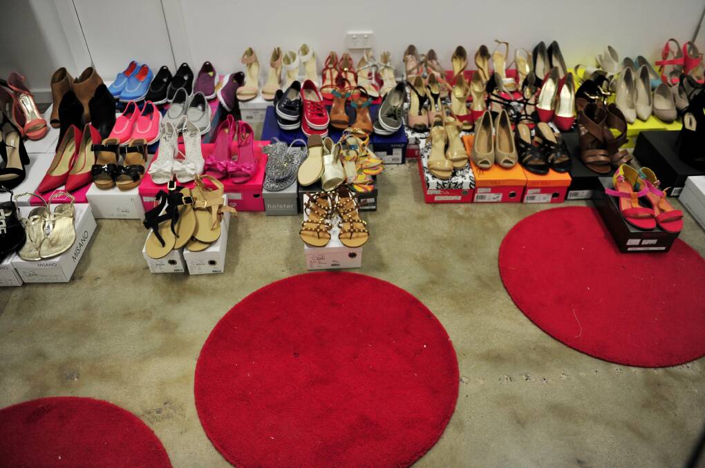 Shoes lined up to be photographed for the online business. Picture: Jay Cronan