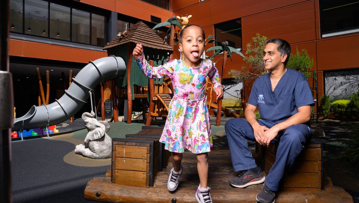 Ahead of her fifth birthday next week, Audrey Fawole returned to Canberra Hospital on Friday to thank her life-saving surgeon Dr Rajay Rampersad. Picture by Sitthixay Ditthavong