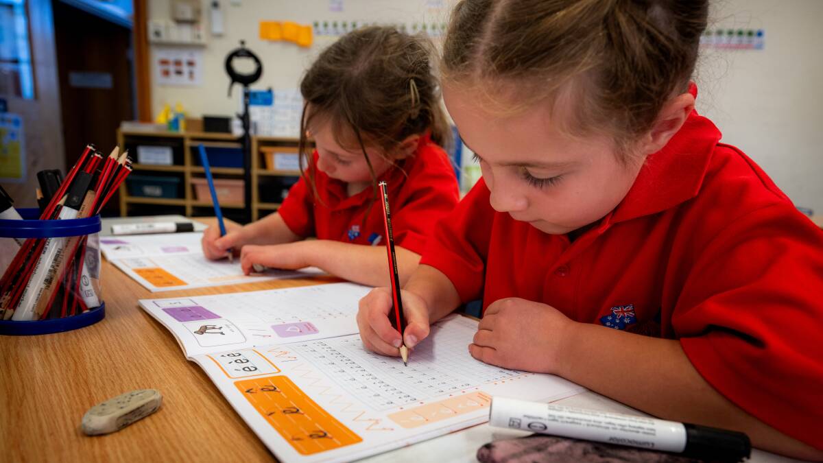Year 1 students, Camille Le Nevez, 6, and Clara Richard, 7, in the French stream at Telopea Park School practice handwriting. Picture by Elesa Kurtz