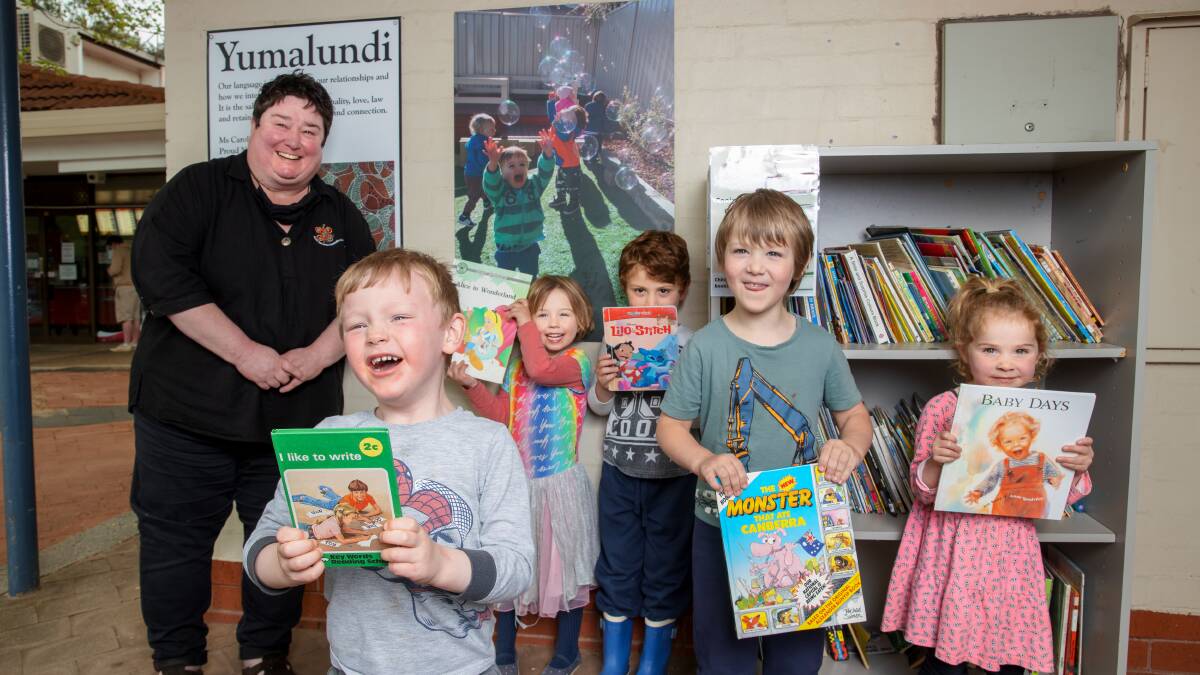 Cooinda Cottage Early Childhood Centre director Molly Rhodin with Hunter Barnes, 3, Vivienne Morton, 4, Matthew Mula, 4, Lincoln Lueckhof, 5, and Eva Zarebski, 3, with their community library. Picture: Sitthixay Ditthavong