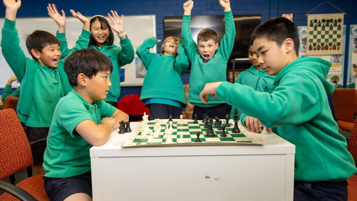 Kaleen Primary School chess club members cheer on Tomoki Horikawa, 10, and Ethan Li, 11. Picture by Gary Ramage